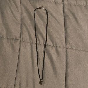 Black beaded necklace and circle pendant